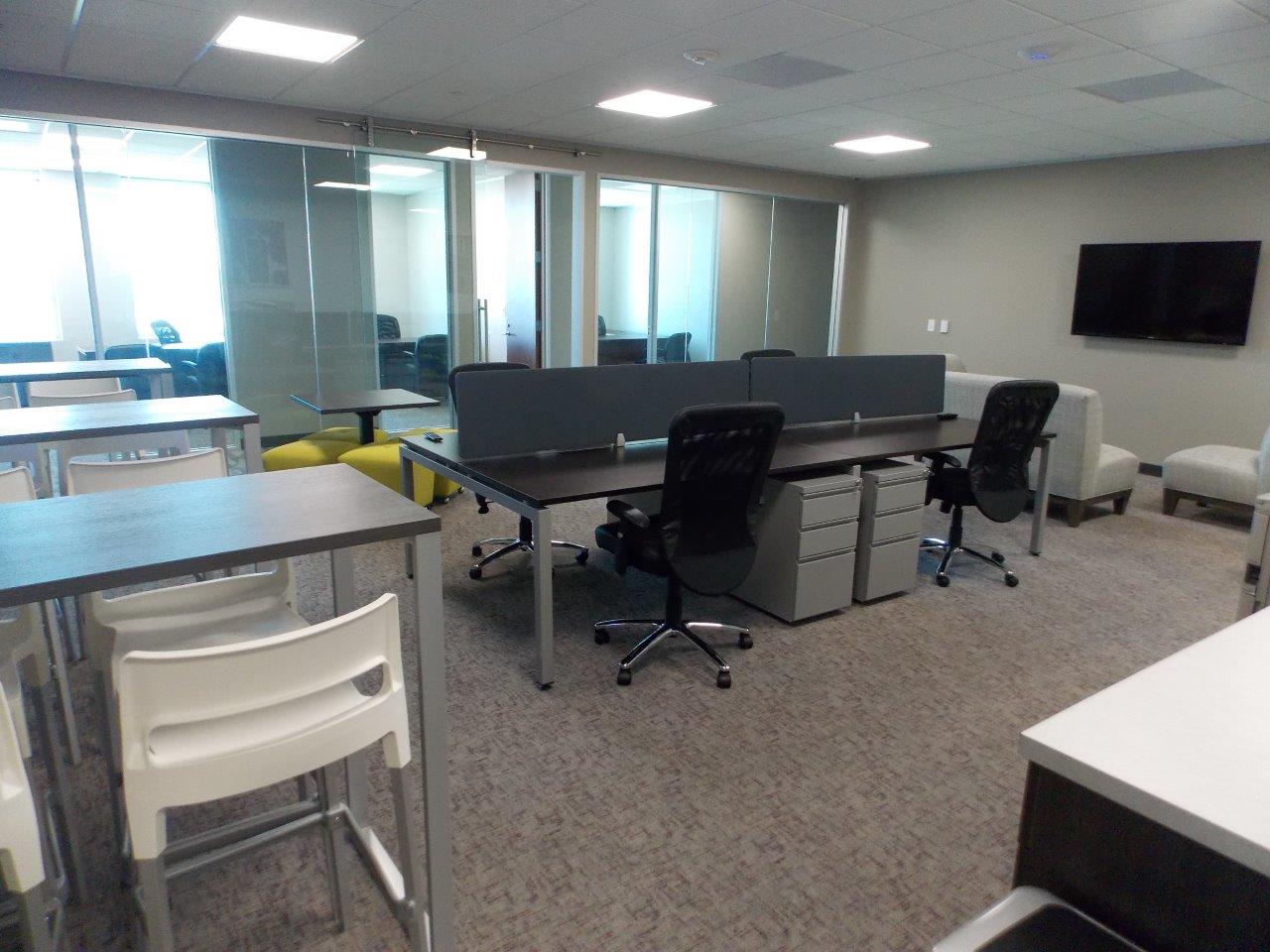 A room with a lot of tables and chairs in it