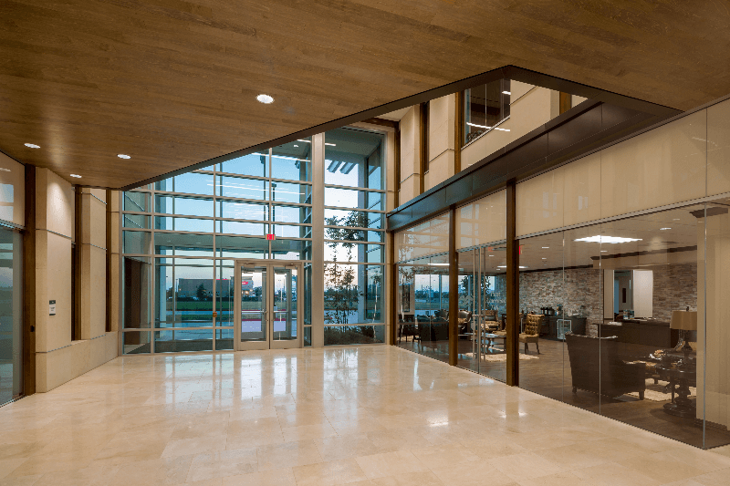 A large lobby in a building with a lot of windows.