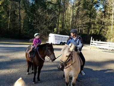 Teacher leading young girl on horse - Horse riding lessons in Olalla WA Teacher leading young girl on horse - Horse riding lessons in Olalla WA