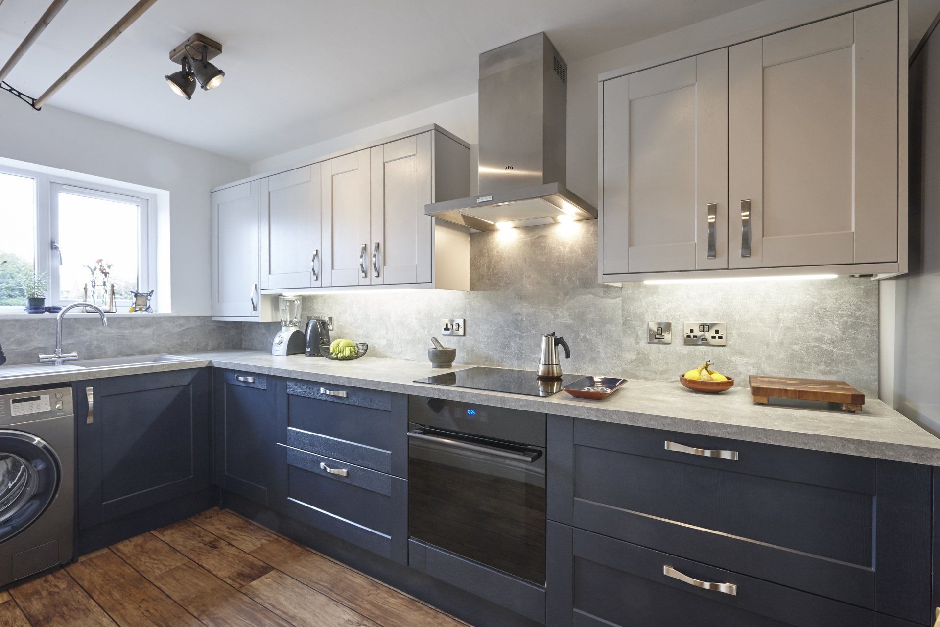 A kitchen with stainless steel appliances and blue cabinets