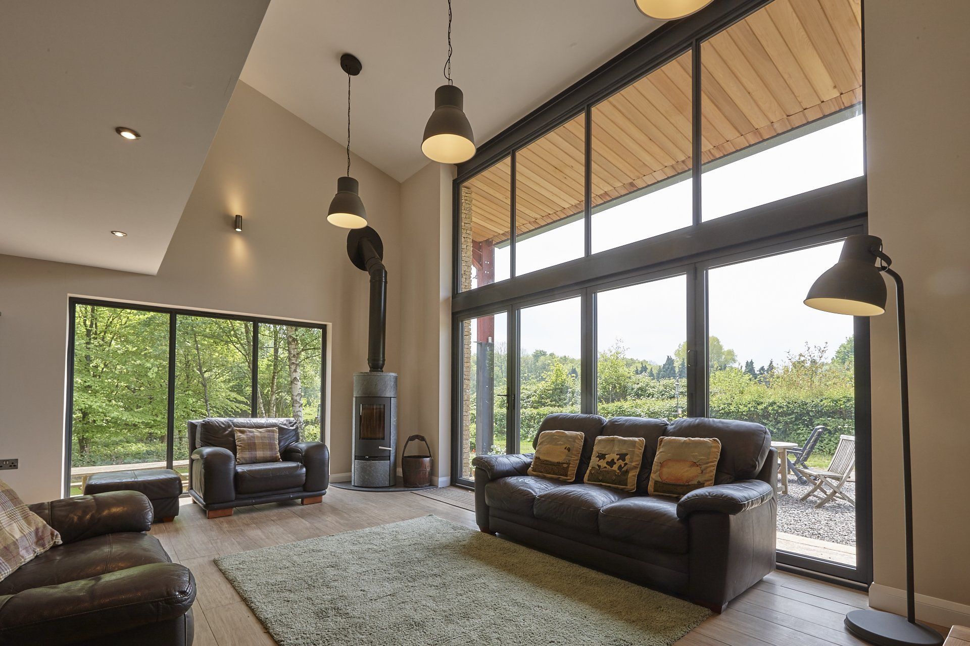 A living room with a couch , chairs , and a fireplace.