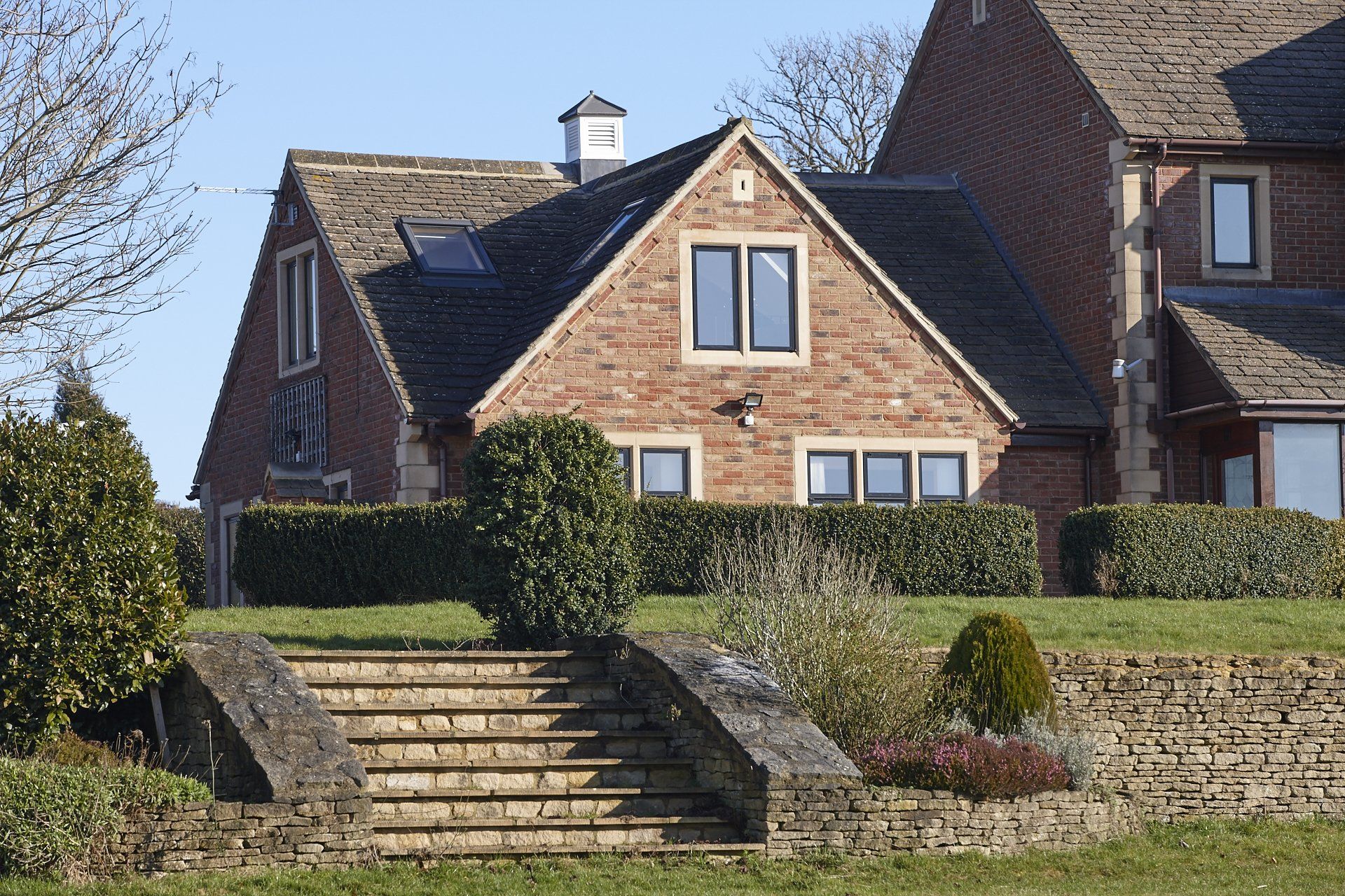 A brick house with stairs leading up to it