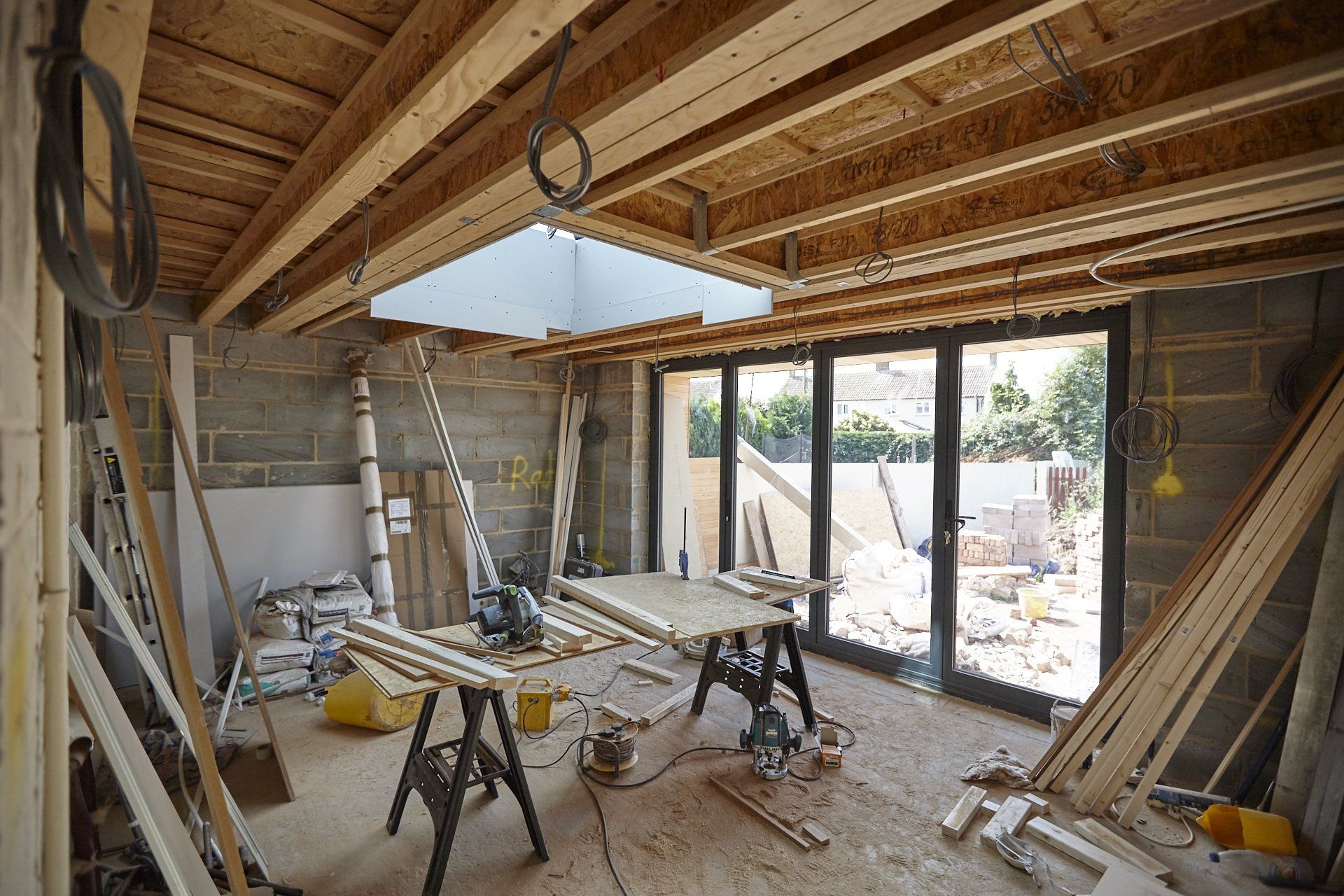 A room under construction with a lot of wood and tools.