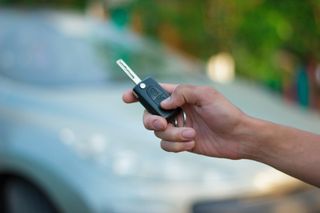 The hand holding the key FOB from the vehicle - truck accessory store in Valparaiso, IN The hand holding the key FOB from the vehicle - truck accessory store in Valparaiso, IN