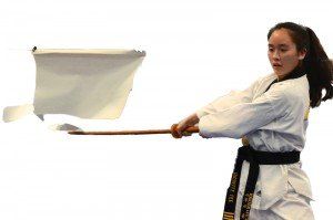 Irvine Taekwondo Programs — Young Woman Demonstrate With Black Belt Weapon Techniques in Pkwy Irvine, CA Irvine Taekwondo Programs — Young Woman Demonstrate With Black Belt Weapon Techniques in Pkwy Irvine, CA