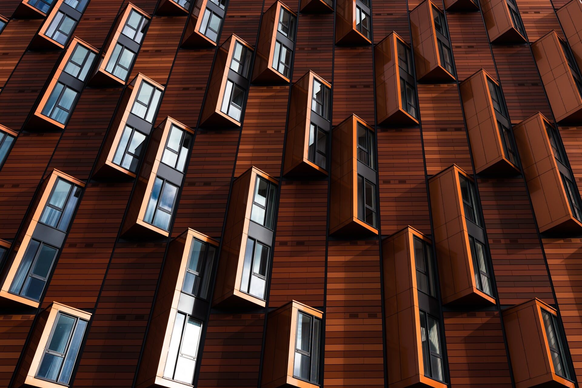 A building with a lot of windows on it is made of wood.
