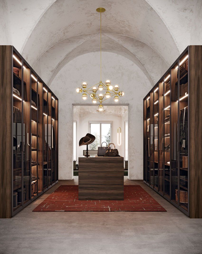 Dressing room, walking wardrobe. Bespoke dressing room, accessories organiser island and slightly tinted glass doors to display the lighting and clever storage