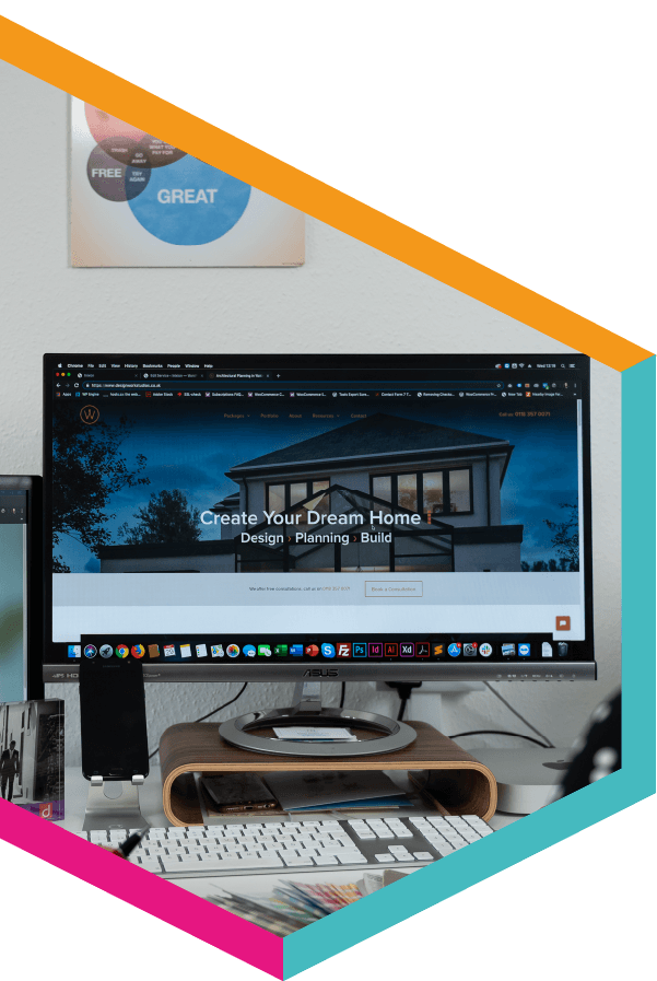 A computer monitor displays a website that says create your dream home