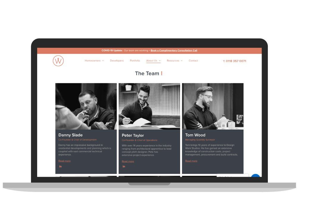 A laptop computer is open to a website with three men on it.