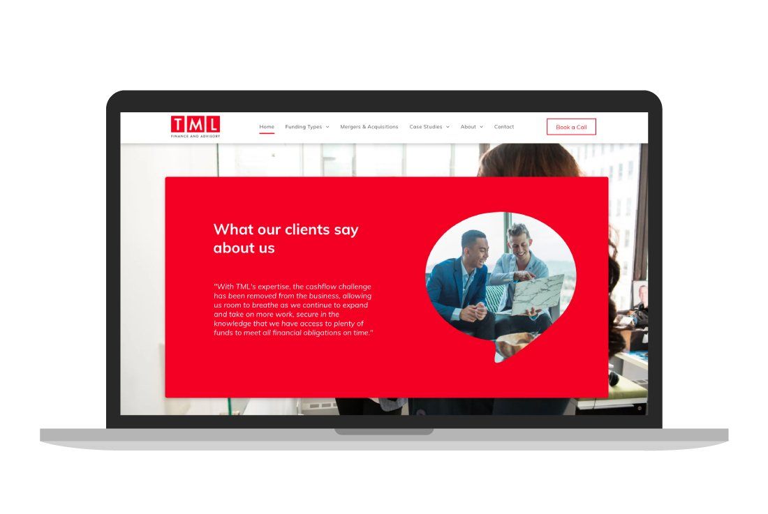 A laptop computer is open to a website with a picture of two people looking at a laptop.
