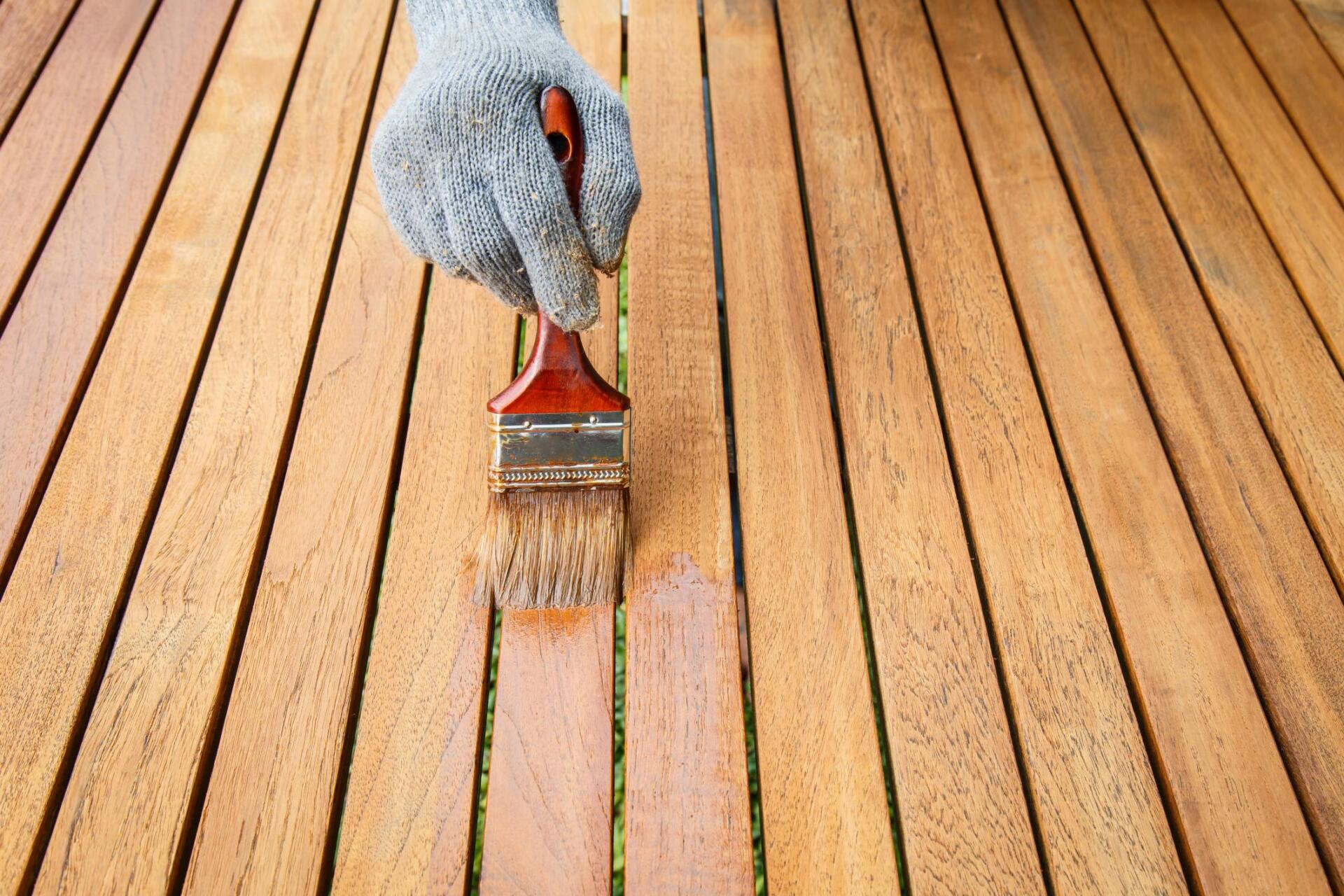 someone staining the wood deck