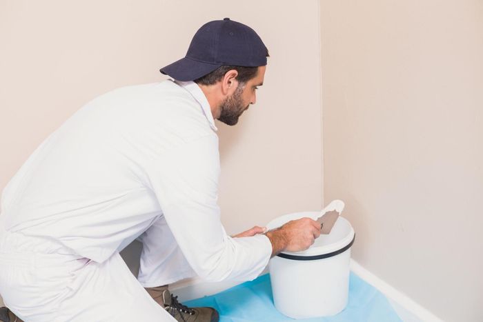 man mixing the can of paint