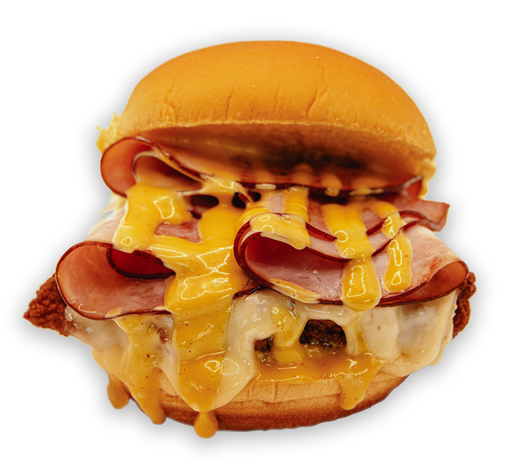 Burger with melted yellow cheese and ham, on a bun.