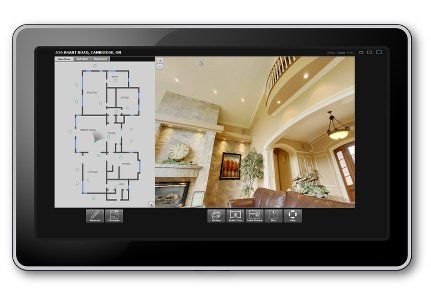 Tablet displaying a home's floor plan and an interior view of a room with a fireplace and chandelier.