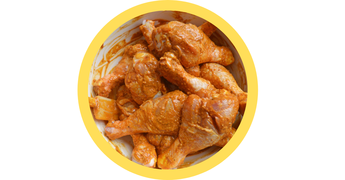 A bowl of marinated chicken wings in a yellow circle on a white background.