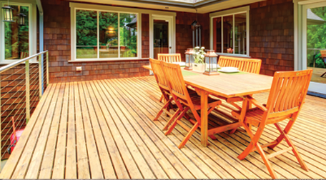 A garden decked area with a table on it