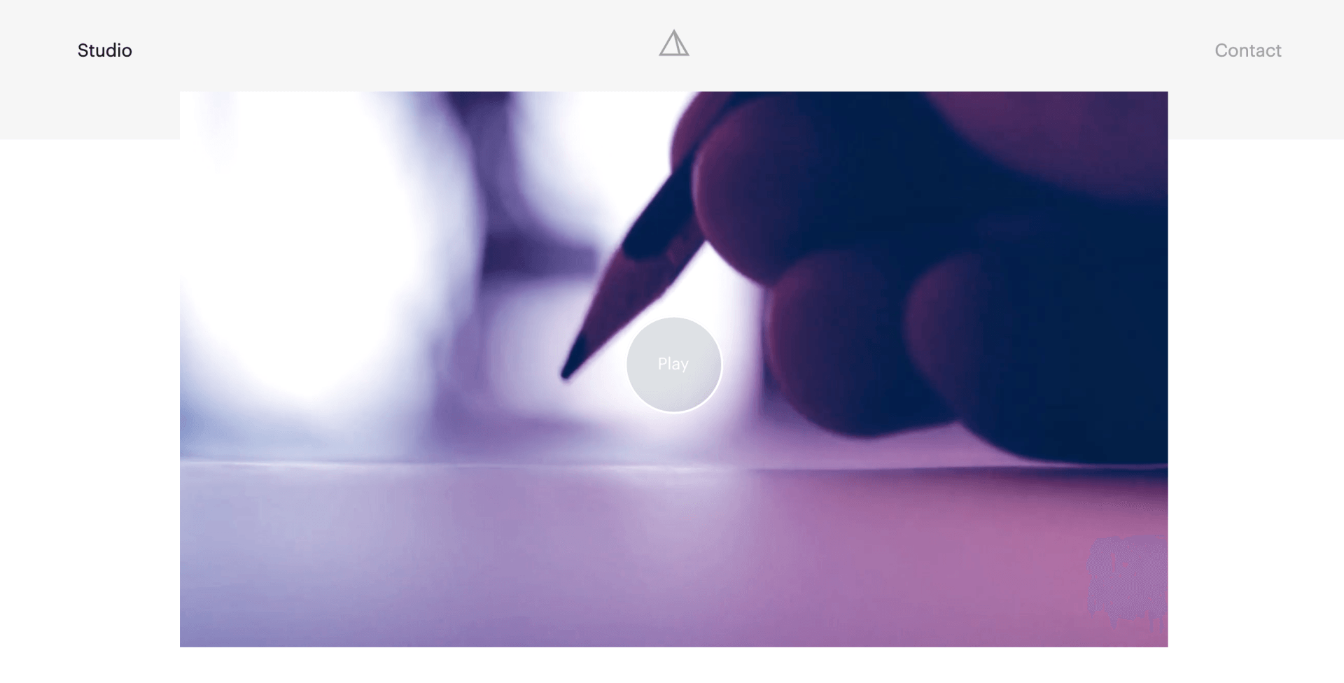 Screenshoot of website that displays an image of a person writing with a pensil