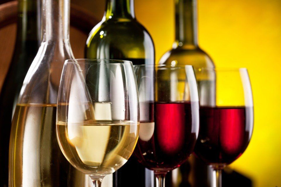 wine in a glass with bottle