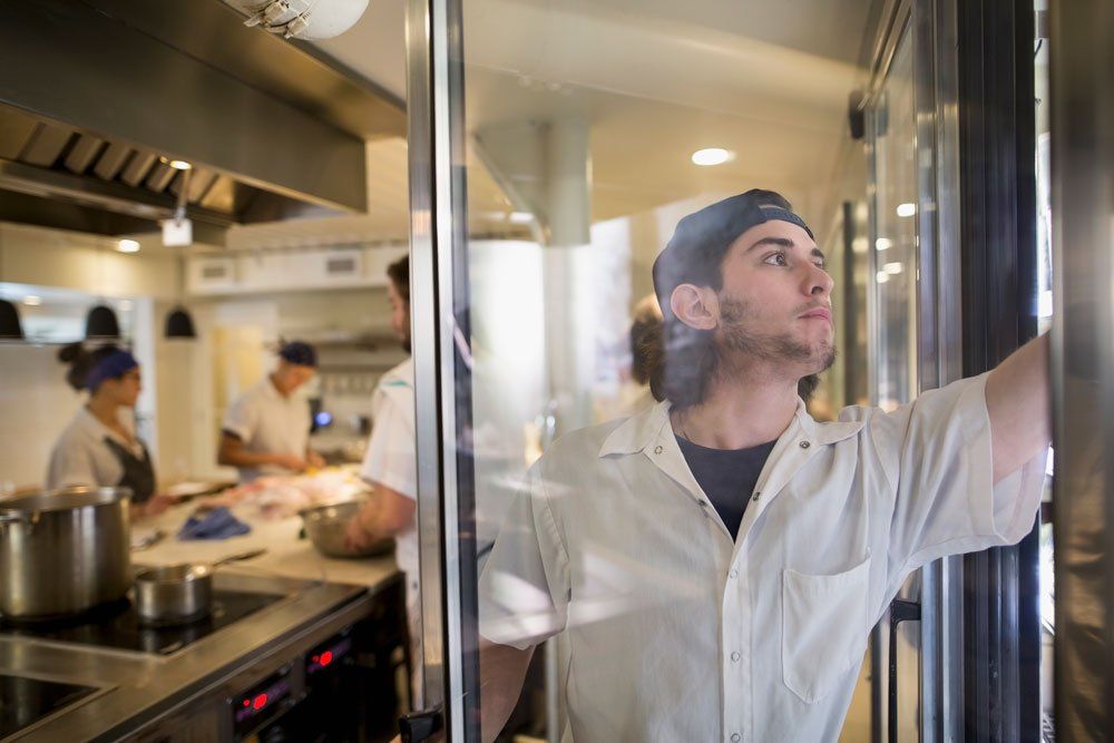 employee getting food from refrigerator