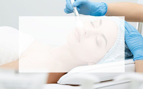 A woman is getting a facial treatment in a beauty salon.
