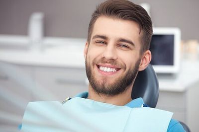 Portrait of happy patient in dental chair - general dentistry in Gurnee, IL