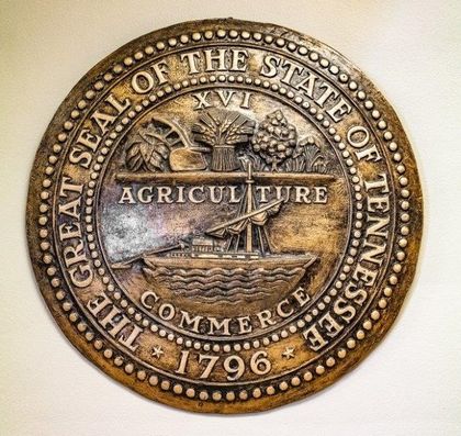 Tennessee state seal: agriculture & commerce symbols in a circle; text 
