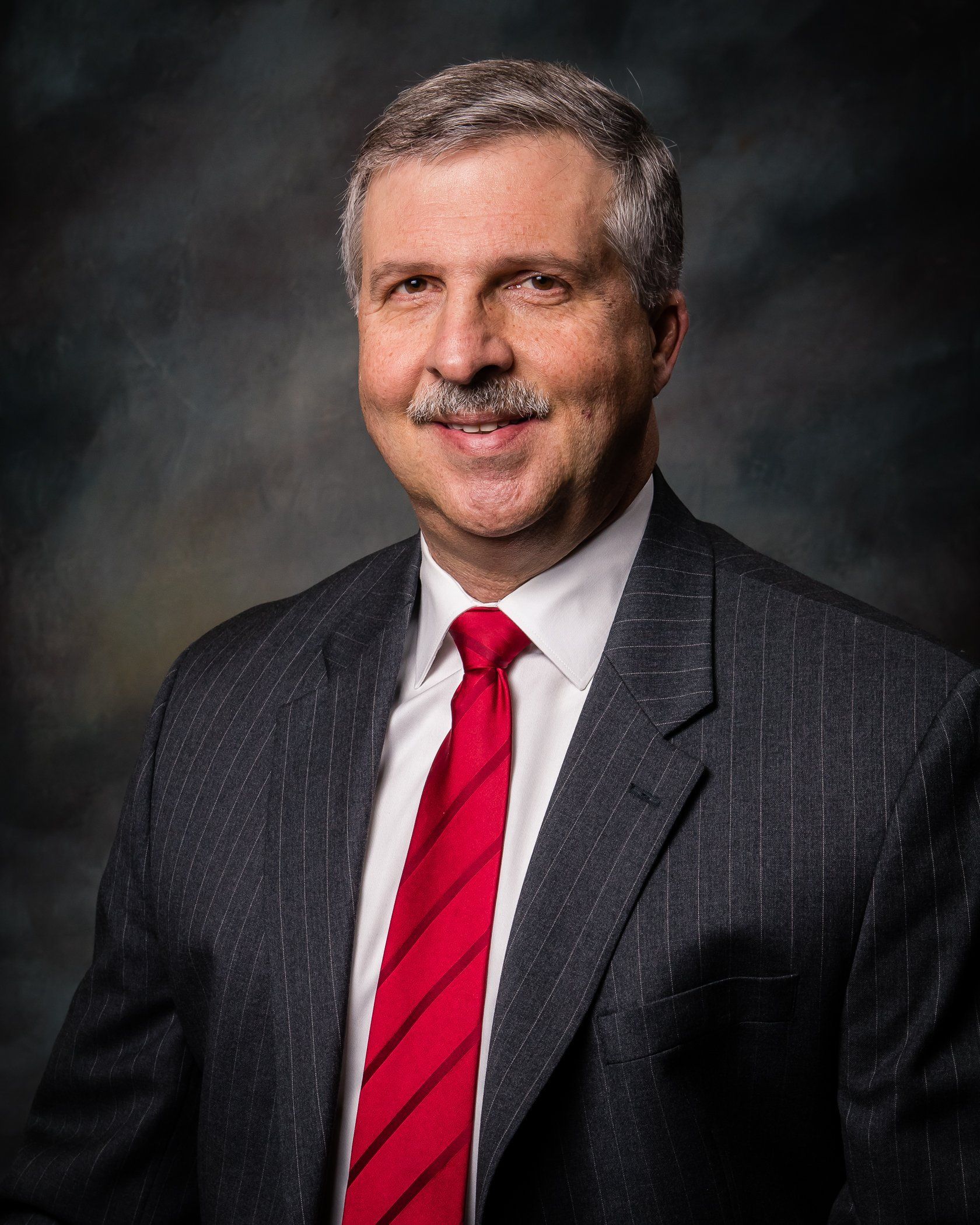 Criminal Attorney — Randy N. Chism in Union City, TN Man in a suit and red tie smiles at the camera.