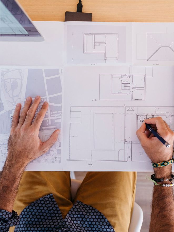Close-up of architect working at home on floor plan