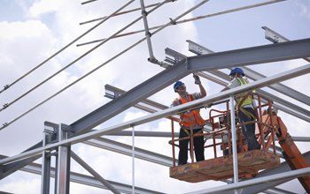 Construction workers in cherry picker