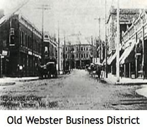 Old Webster business district, circa 1910, featuring brick buildings, street, and horse-drawn carriages.