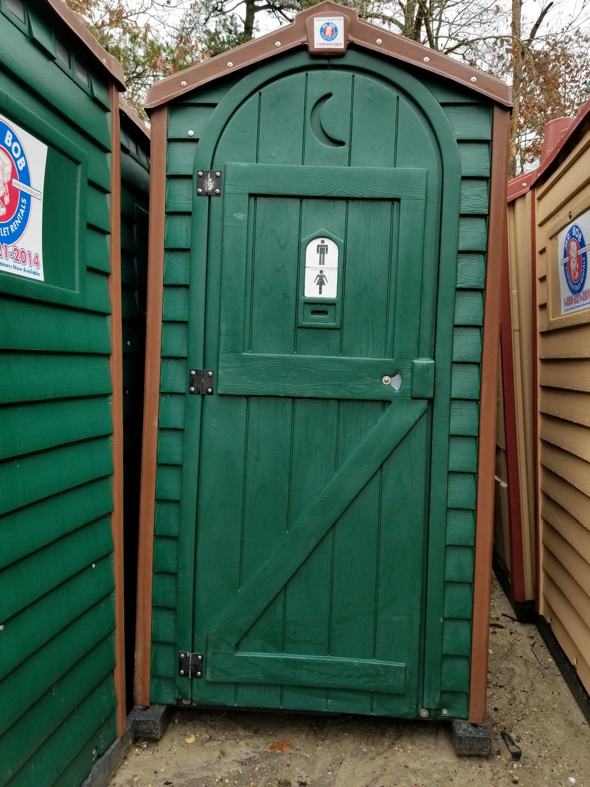 Green portable toilet with brown trim and gender sign.