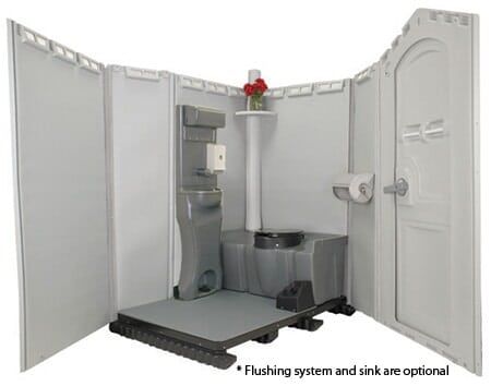 Open portable toilet with optional flushing and sink; gray interior, white walls, and a small floral arrangement.