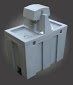 Gray, blocky machine with raised section, possibly industrial equipment.