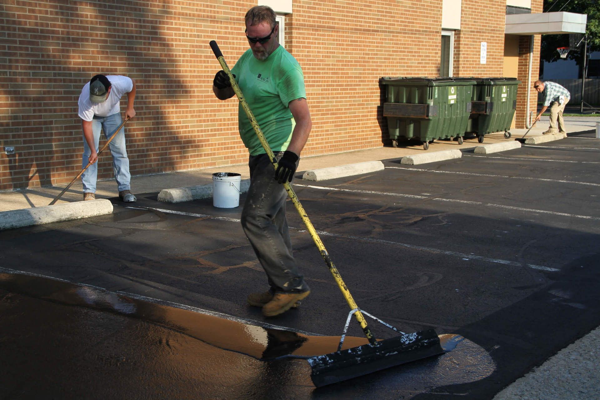 Dublin CPS technician sealcoating a parking lot