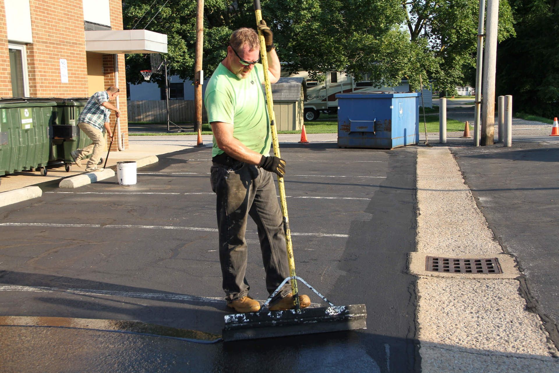 Dublin CPS technician sealcoating a parking lot