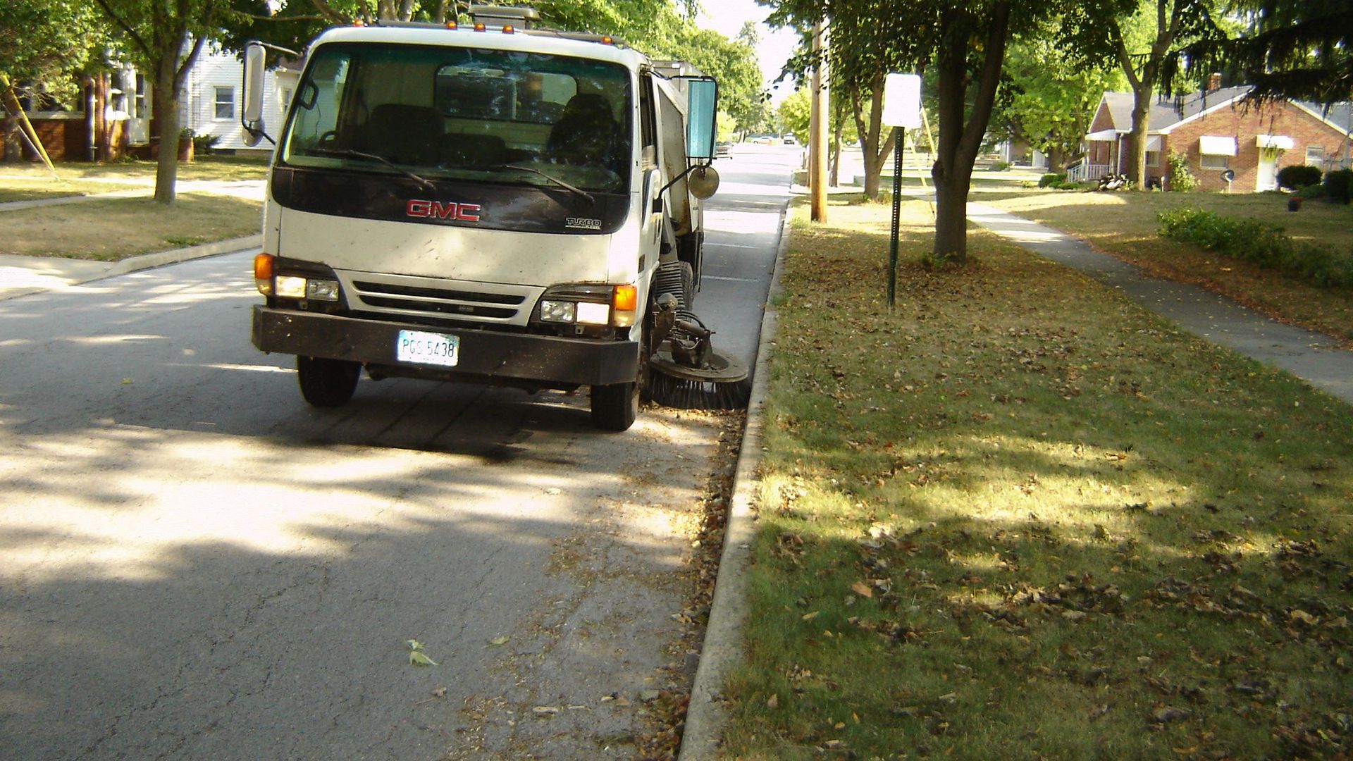 Sweeper truck cleaning up leaves