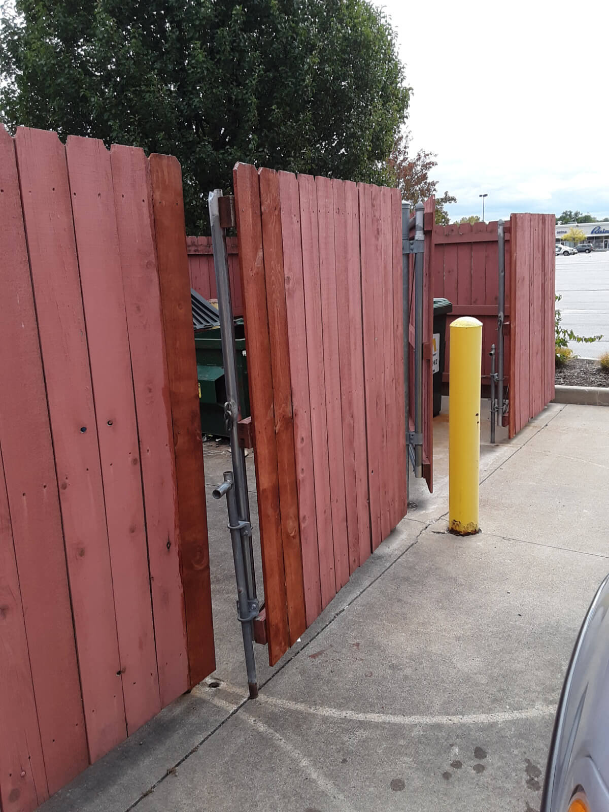 Fence Repair and staining job finished in Toledo, OH Shopping Center
