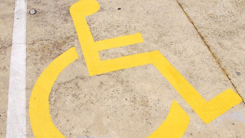 Parking Lot Striping Services. A handicap symbol painted on a parking lot.