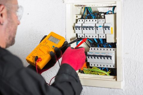 electrical engineers testing using multi-meter probe