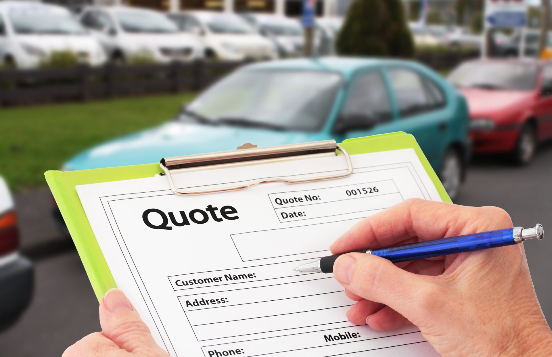 A person is holding a clipboard with a quote on it.