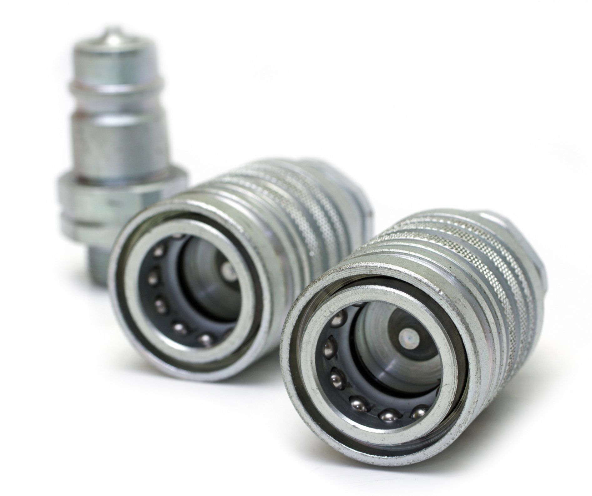Three silver metal quick-connect couplings, two in front and one standing behind on a white background