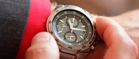una mano che tiene la cassa di un orologio da polso