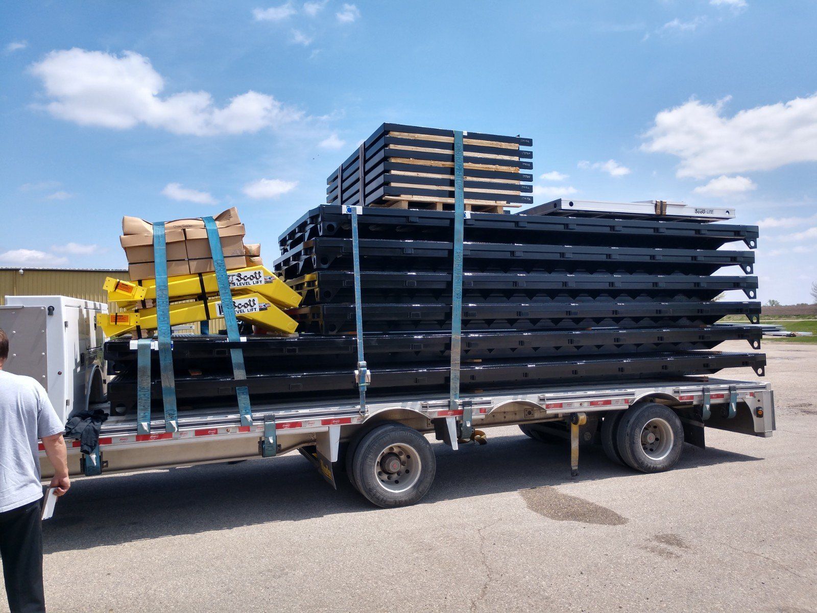 A truck with a stack of pallets on top of it