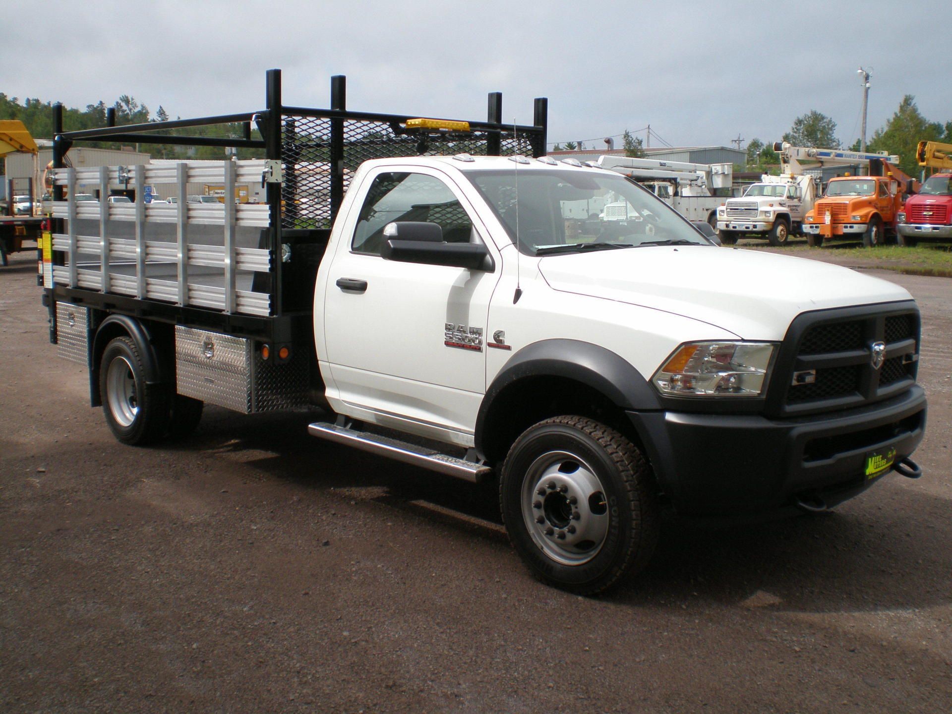 A white dodge ram truck is parked in a parking lot