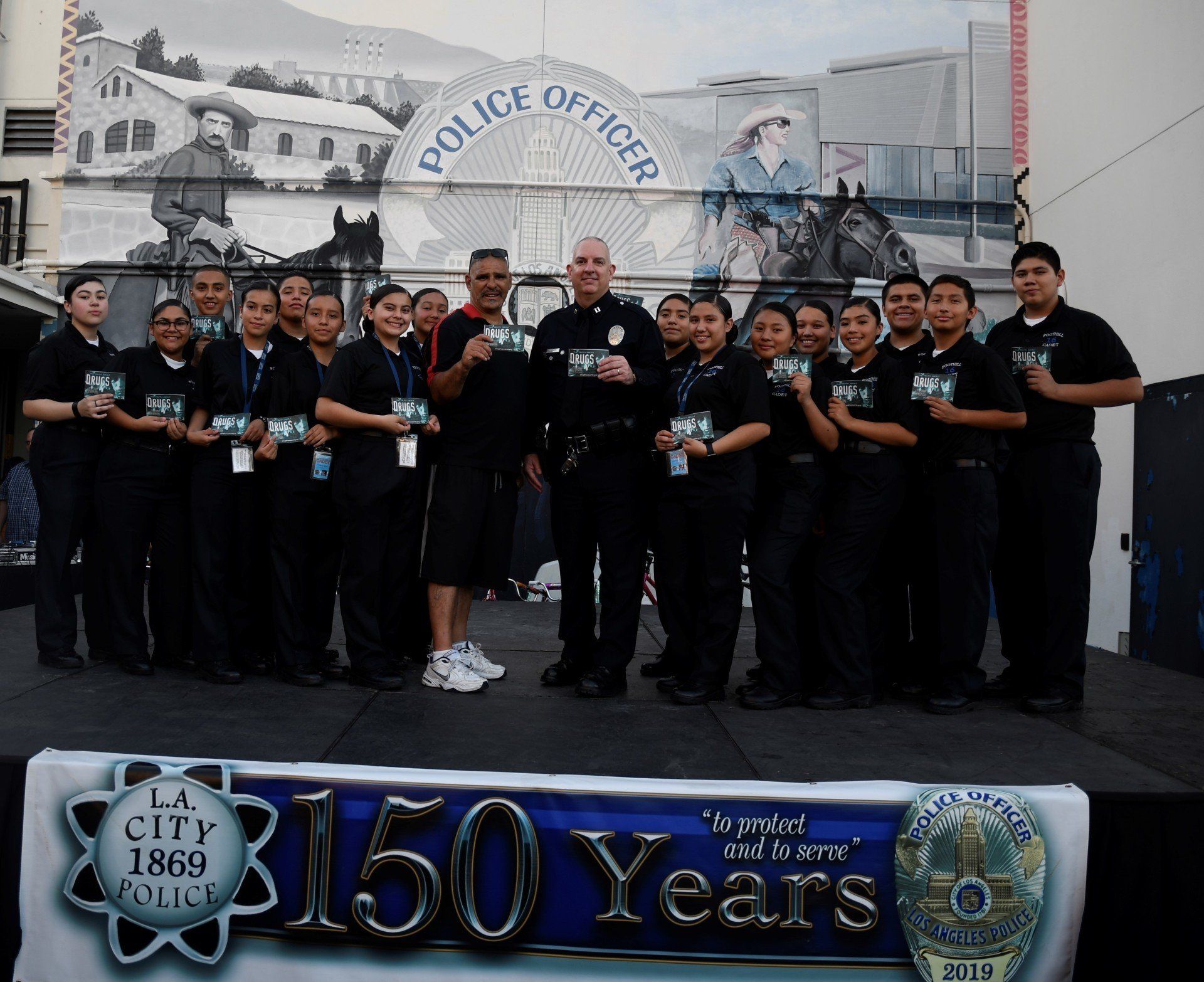 A group of police officers standing in front of a 150 years sign
