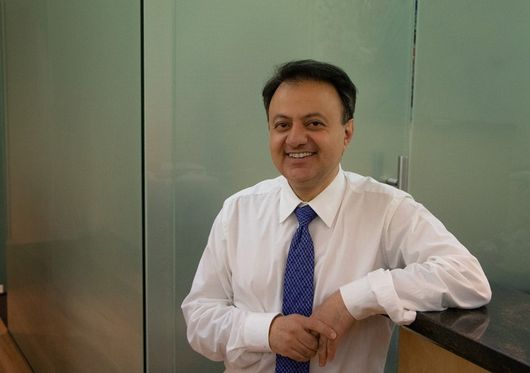 doctor leaning on counter and smiling
