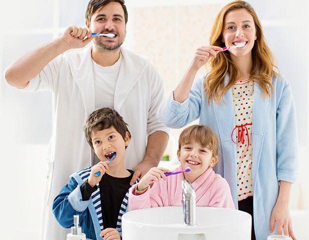 family brushing teeth