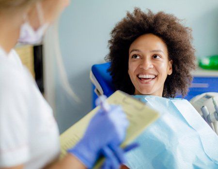 Porcelain Veneers — Woman Having a Consultation with a Dentist in Hoover, AL Porcelain Veneers — Woman Having a Consultation with a Dentist in Hoover, AL