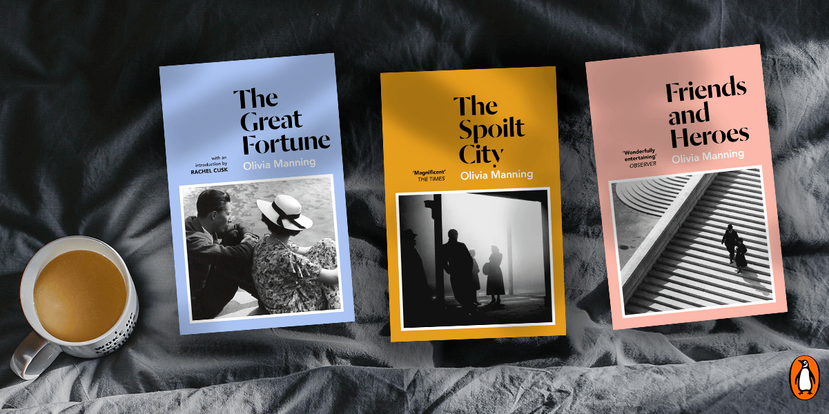 Three books by Olivia Manning: The Great Fortune, The Spoilt City, and Friends and Heroes, next to a mug on a gray blanket.