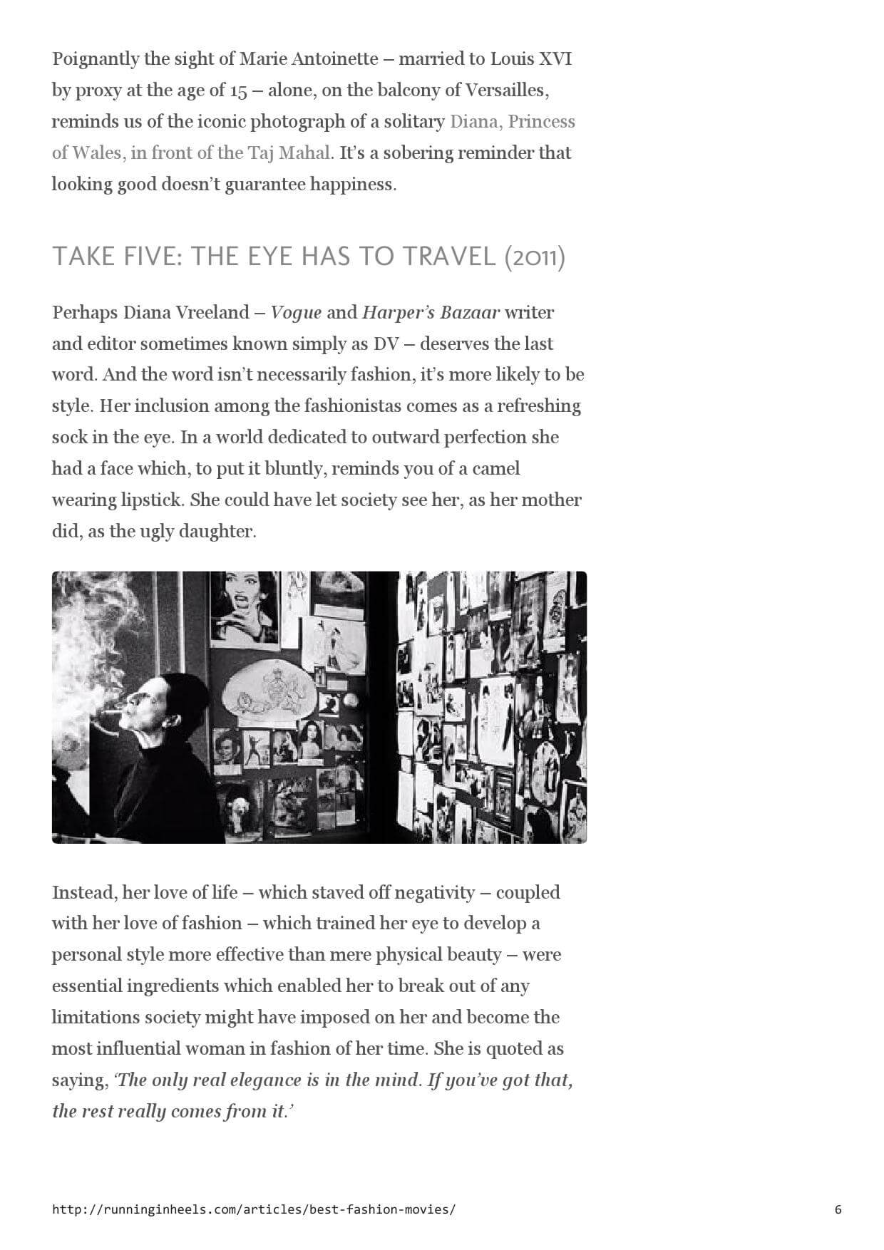 A black-and-white photograph of Diana Vreeland, profile view, smoking, in front of a wall crowded with framed pictures.